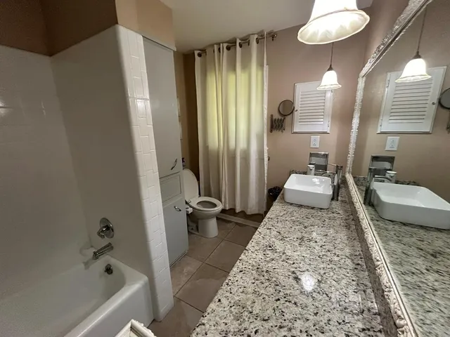 a bath room with a couch and a rug