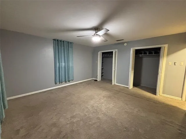 a view of a big room with closet and chandelier fan
