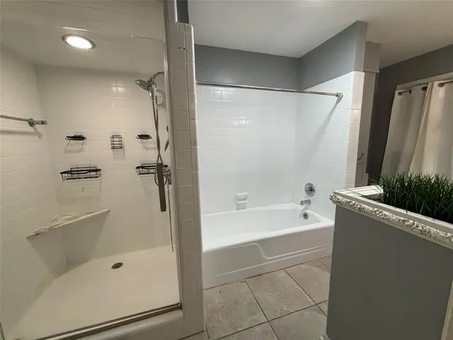a bathroom with a bathtub a toilet and a shower