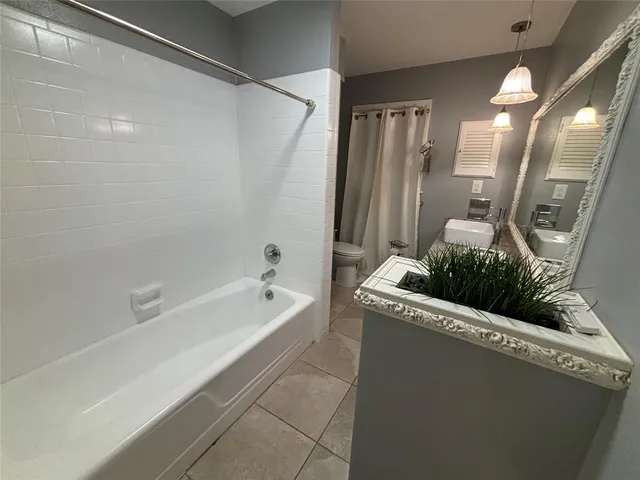 a bathroom with a tub and shower