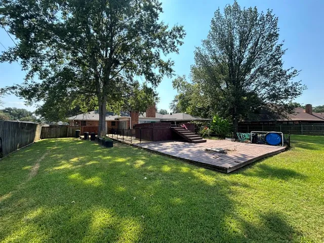 a view of a backyard with seating space
