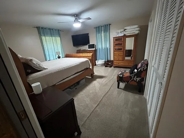 a bedroom with furniture and a flat screen tv