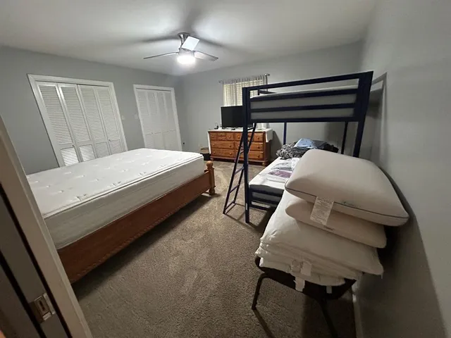 a bedroom with a bed and a furniture