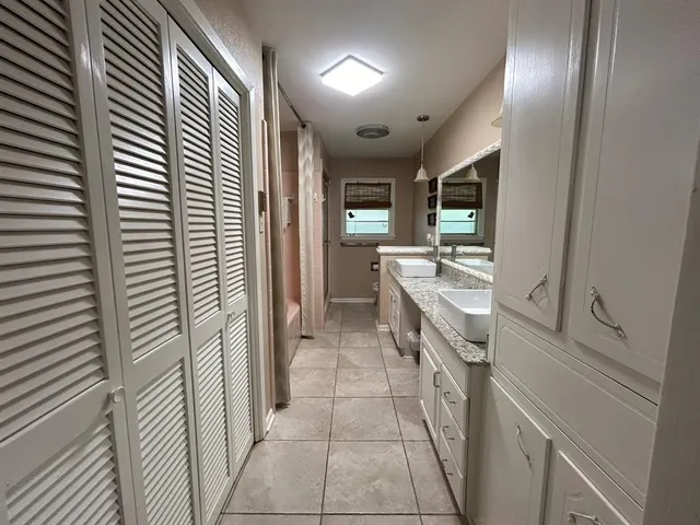 a bathroom with a sink a mirror and a shower