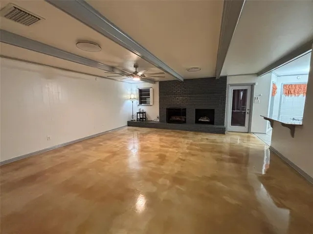a view of empty room with a fireplace