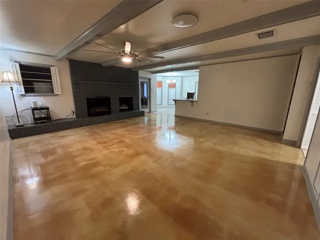 a view of empty room with a fireplace