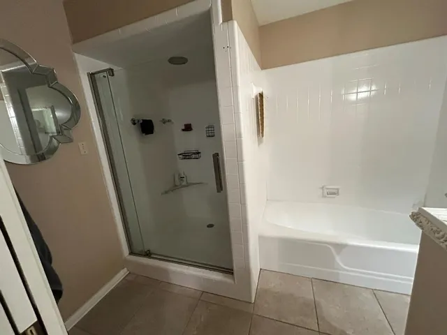 a bathroom with a bathtub and a shower