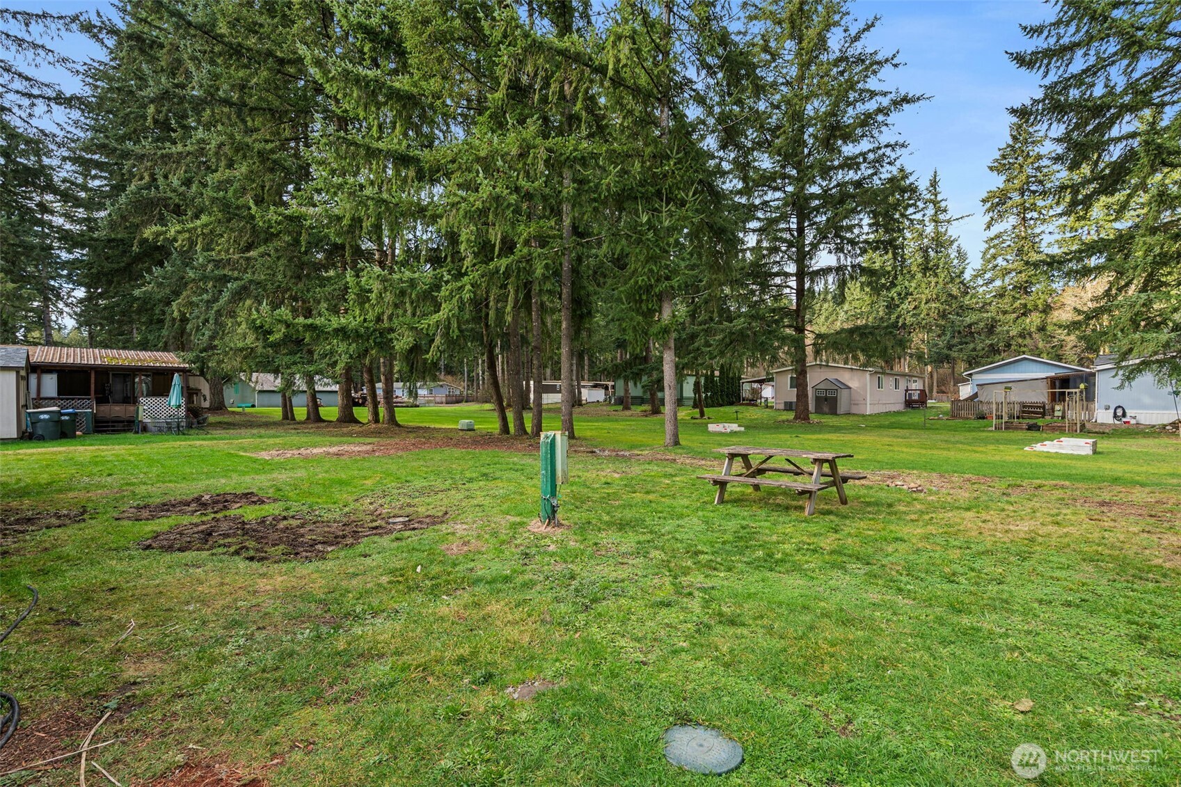17340 Sargent Road Southwest, Unit 17 Rochester, WA 98579 - Photo 21 of 23 a garden with trees in the background