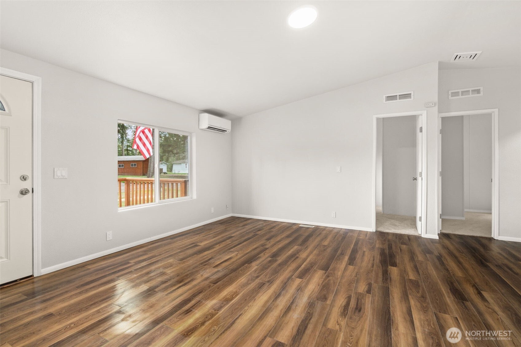 17340 Sargent Road Southwest, Unit 17 Rochester, WA 98579 - Photo 4 of 23 a view of an empty room with wooden floor and a window