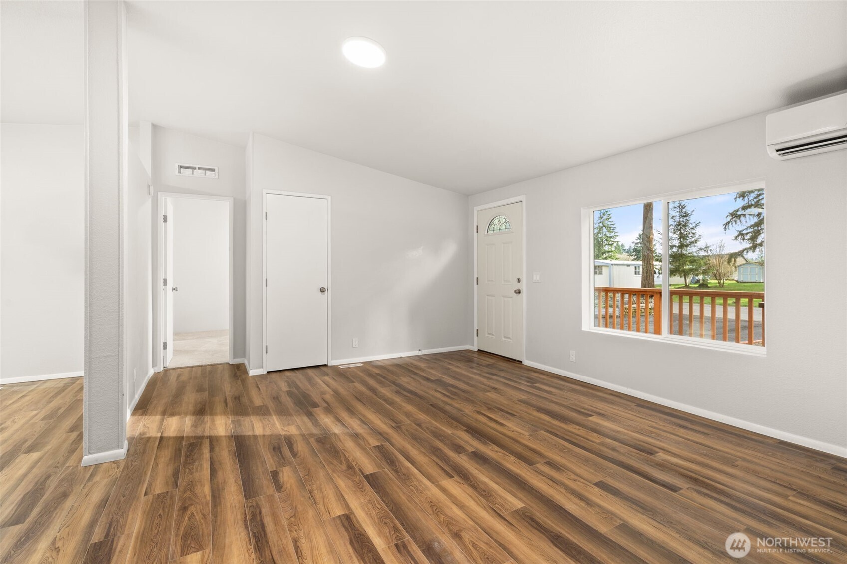 17340 Sargent Road Southwest, Unit 17 Rochester, WA 98579 - Photo 5 of 23 a view of a bedroom with wooden floor and windows
