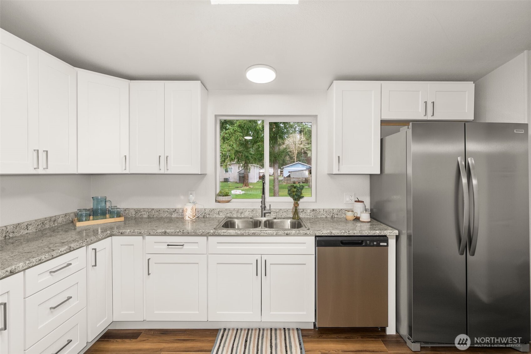 17340 Sargent Road Southwest, Unit 17 Rochester, WA 98579 - Photo 7 of 23 a kitchen with a sink window and cabinets