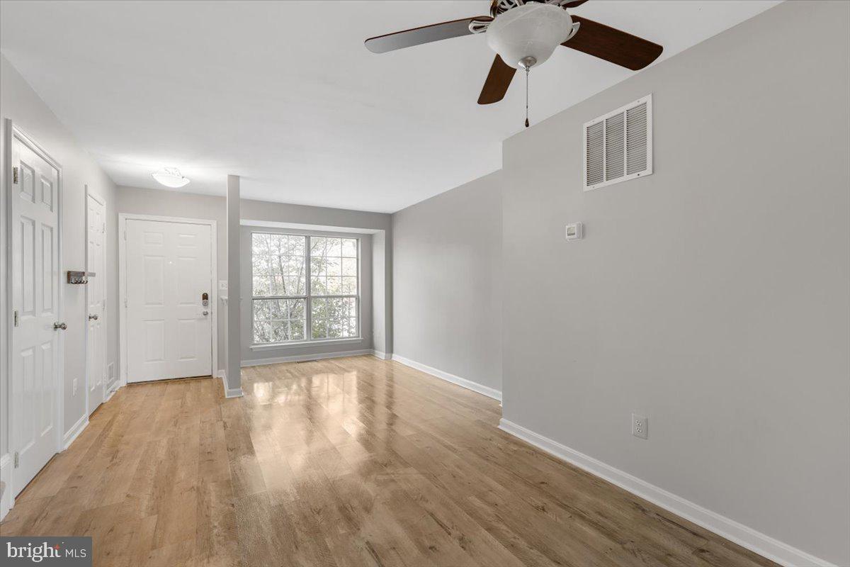 14159 Autumn Circle Centreville, VA 20121 - Photo 2 of 34 a view of an empty room with wooden floor and a window