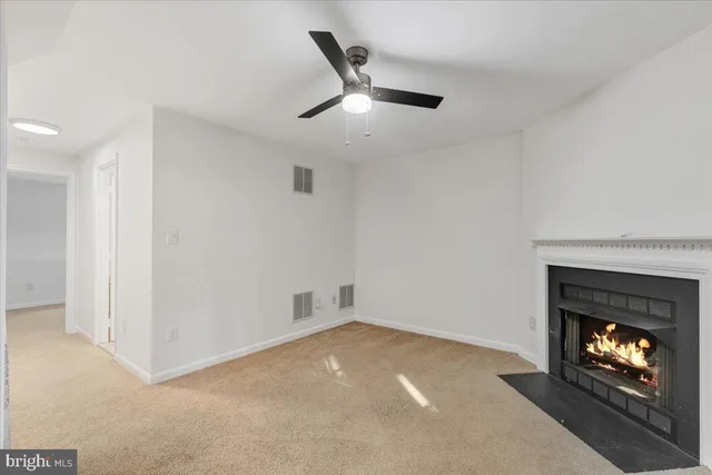 a view of an empty room with fire place and a fireplace