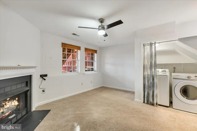 a view of a livingroom with a fireplace and windows