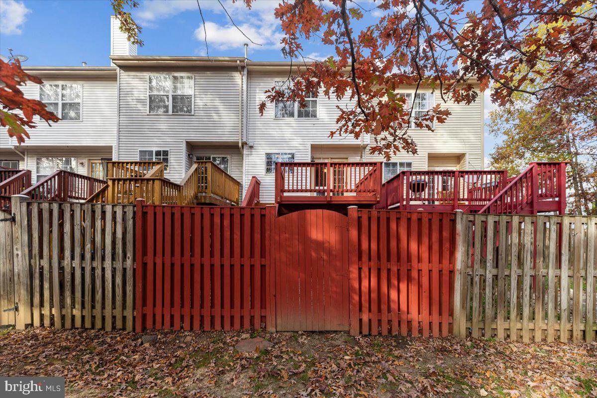 14159 Autumn Circle Centreville, VA 20121 - Photo 33 of 34 a view of a brick house with wooden fence