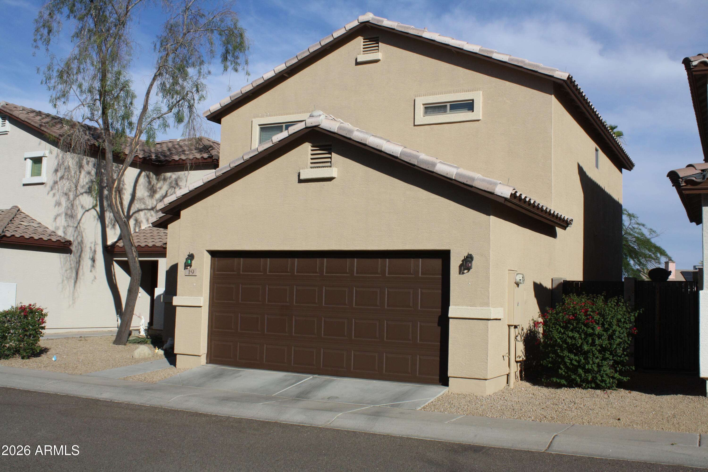 10225 West Camelback Road, Unit 19 Phoenix, AZ 85037 - Photo 51 of 51 a front view of a house with garage