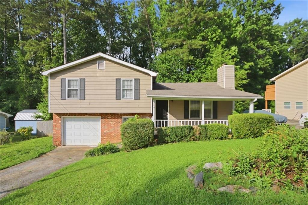 1496 Cherry Hill Road Southwest Conyers, GA 30094 - Photo 1 of 32 a front view of a house with a yard