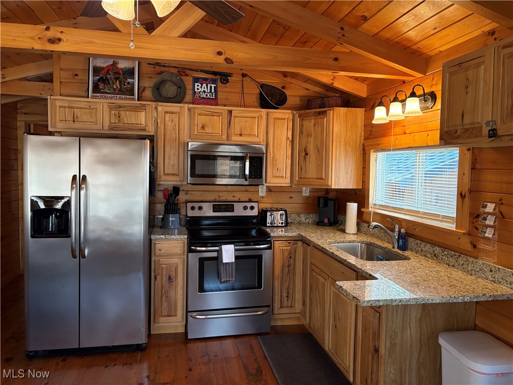 5919 Lake Road West, Unit 15 Ashtabula, OH 44004 - Photo 10 of 26 Kitchen with light stone countertops, appliances with stainless steel finishes, wooden walls, wood ceiling, and dark wood-style floors