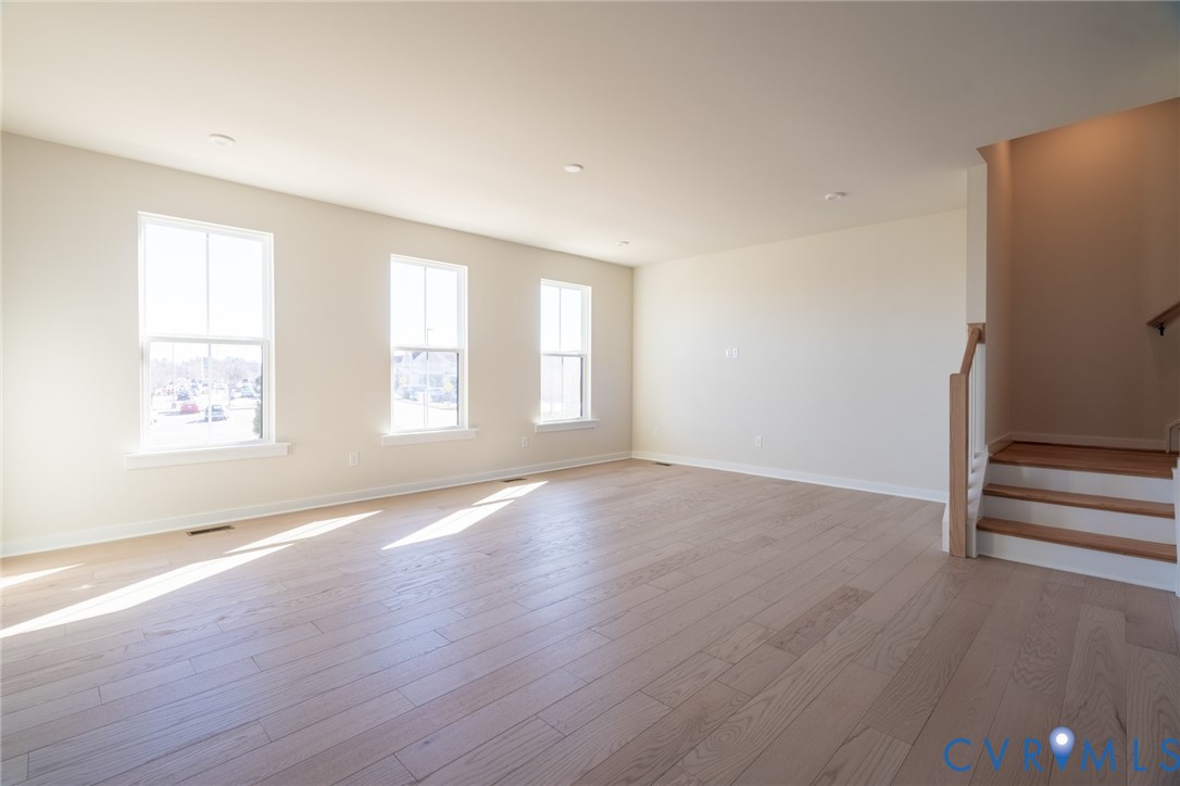 213 Golden Haze Alley, Unit 31 Midlothian, VA 23113 - Photo 3 of 15 an empty room with wooden floor and windows