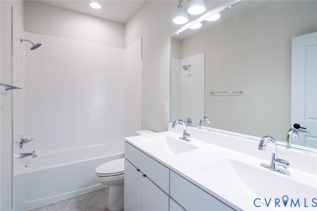 213 Golden Haze Alley, Unit 31 Midlothian, VA 23113 - Photo 8 of 15 a bathroom with a sink a toilet and shower