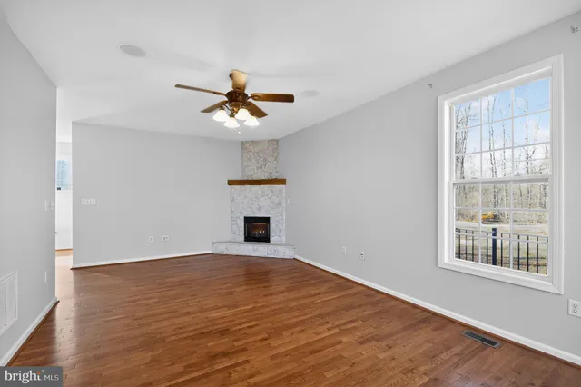 a kitchen with granite countertop wooden cabinets a stove a sink and a refrigerator