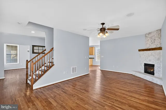 a large kitchen with stainless steel appliances granite countertop a refrigerator a oven and a sink with granite countertops