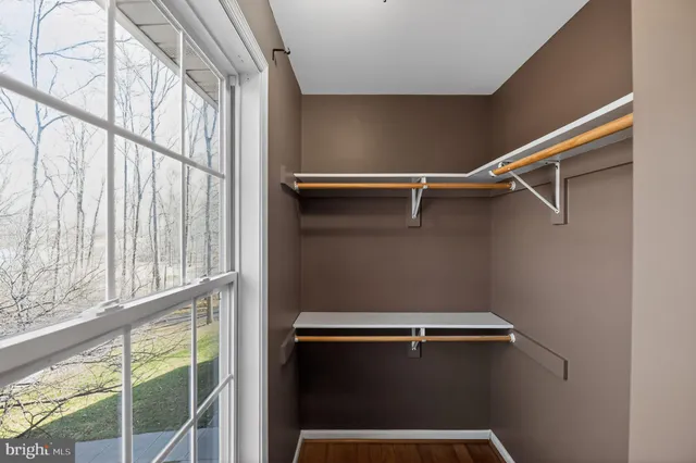 a view of room with hardwood floor and ceiling fan