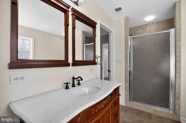 a bathroom with a sink toilet vanity and shower