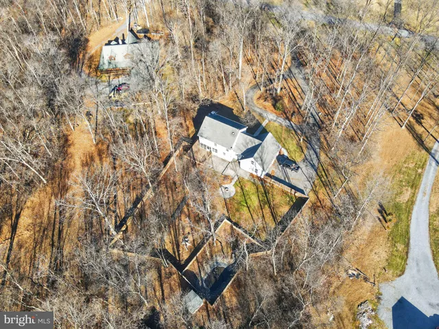 a view of a yard with plants and wooden fence