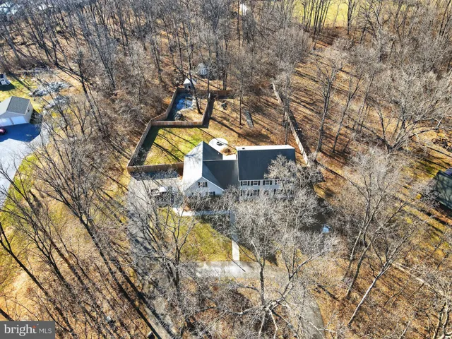 a view of swimming pool with a patio and backyard