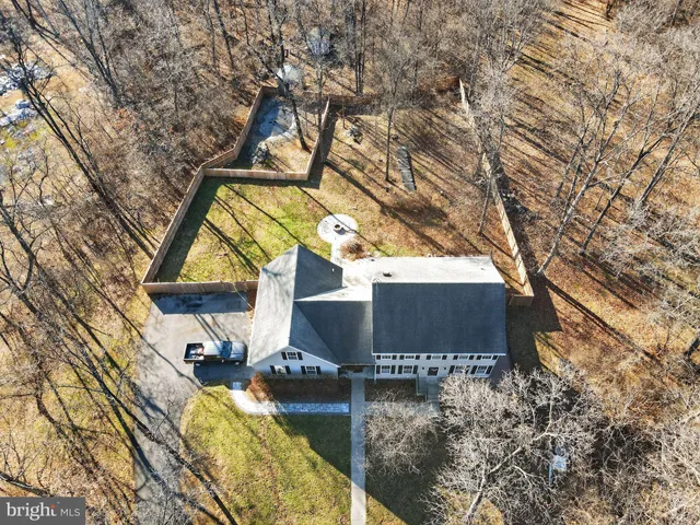 a view of a white house with a yard covered with snow