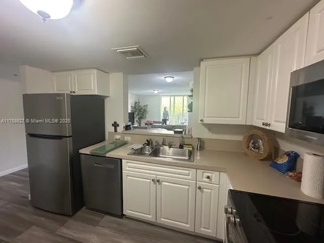 a room with a couch and a potted plant