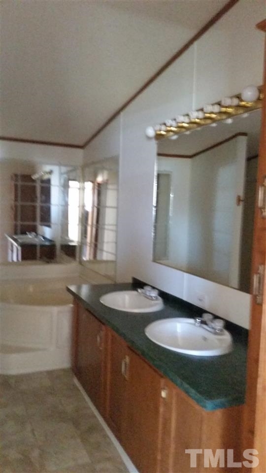 4815 Brown Road Rougemont, NC 27572 - Photo 10 of 23 a bathroom with a granite countertop sink and a mirror