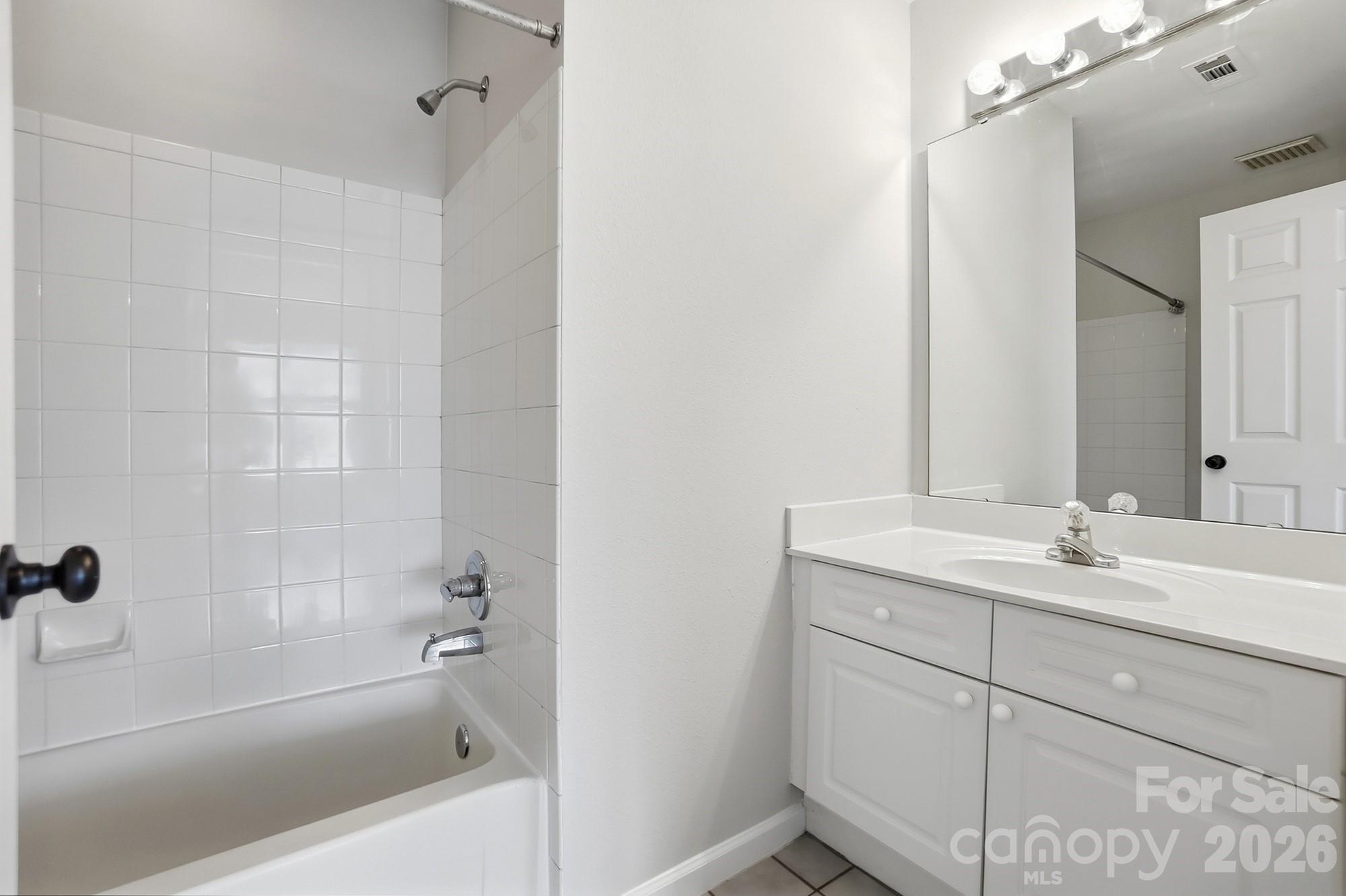 711 Stone Village Drive Fort Mill, SC 29708 - Photo 32 of 46 a bathroom with a granite countertop sink mirror toilet and bathtub