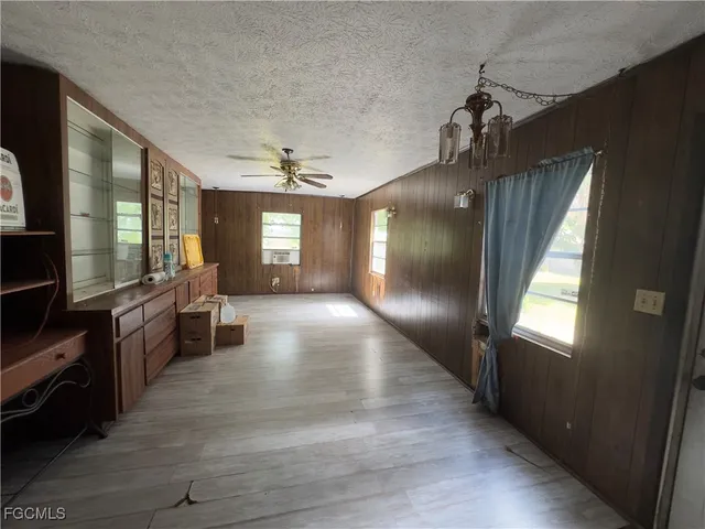 a view of a living room with furniture and a flat screen tv