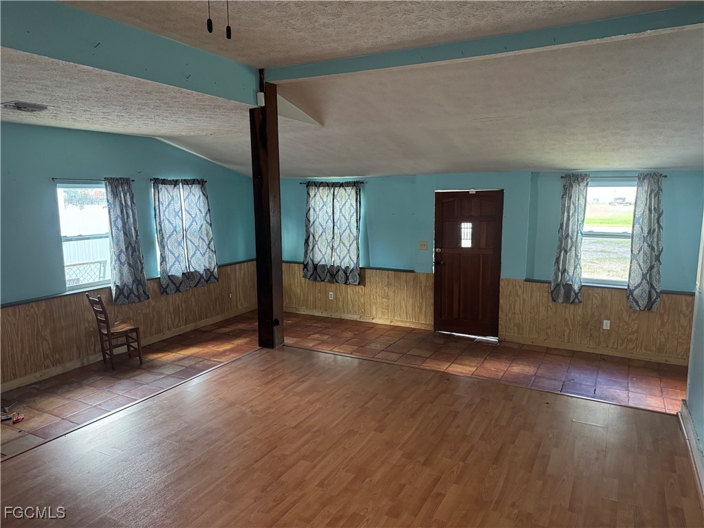 508 East Ventura Avenue Clewiston, FL 33440 - Photo 7 of 14 an empty room with wooden floor and windows