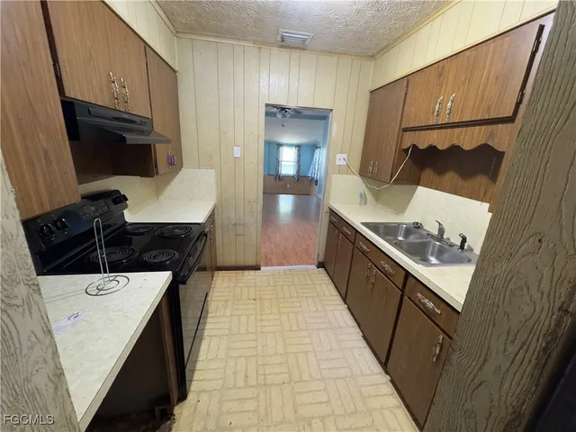 a hallway with sink a washer and dryer