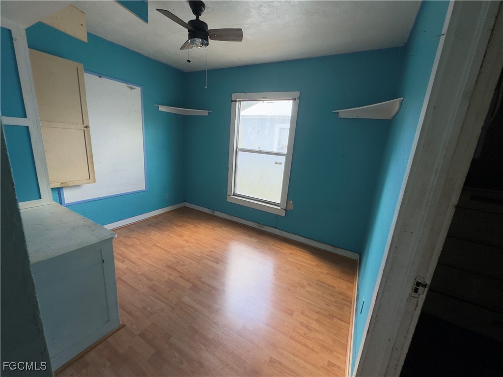 508 East Ventura Avenue Clewiston, FL 33440 - Photo 10 of 14 an empty room with wooden floor and windows