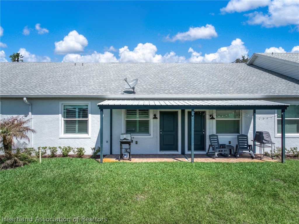 4734 Haw Branch Road, Unit 110 Sebring, FL 33875 - Photo 35 of 50 a front view of house with a garden and patio