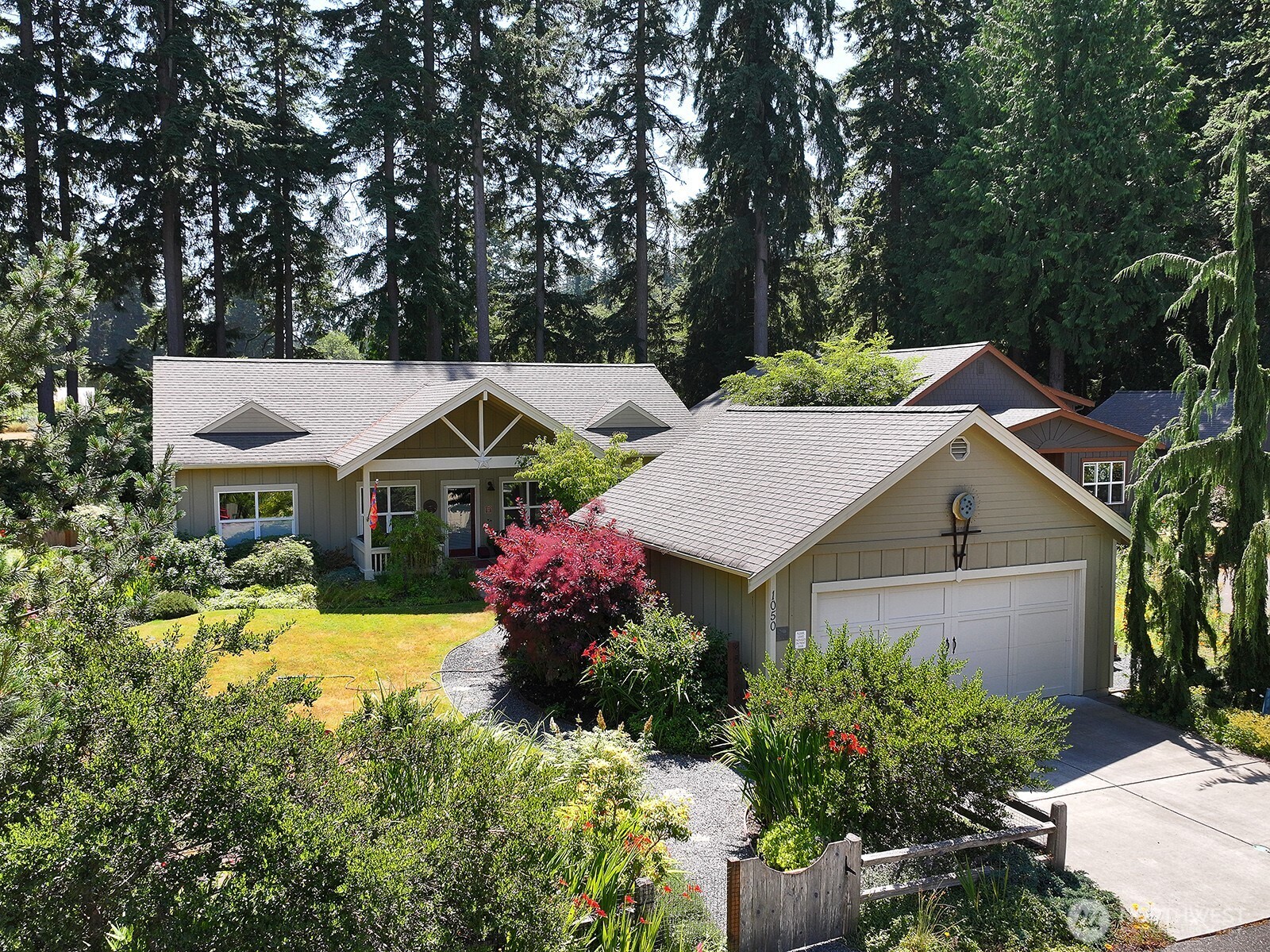 a view of a house with a big yard and potted plants