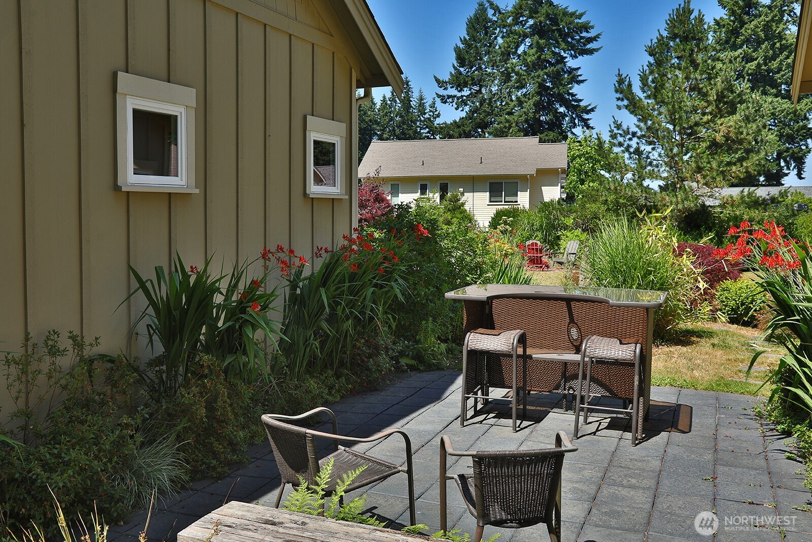 1050 Village Loop Langley, WA 98260 - Photo 13 of 39 a view of a patio with table and chairs and potted plants