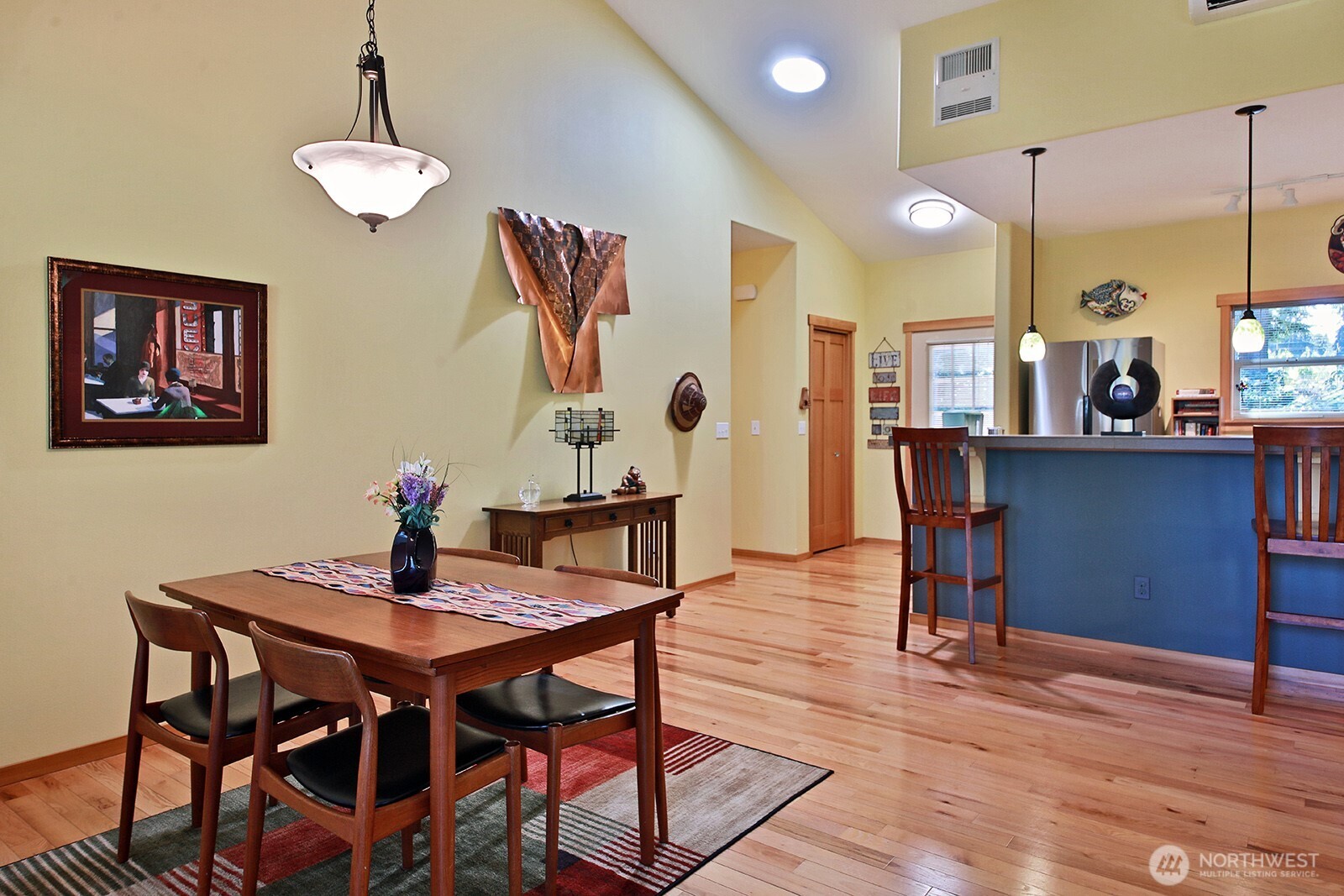 1050 Village Loop Langley, WA 98260 - Photo 21 of 39 a view of a dining room with furniture and wooden floor