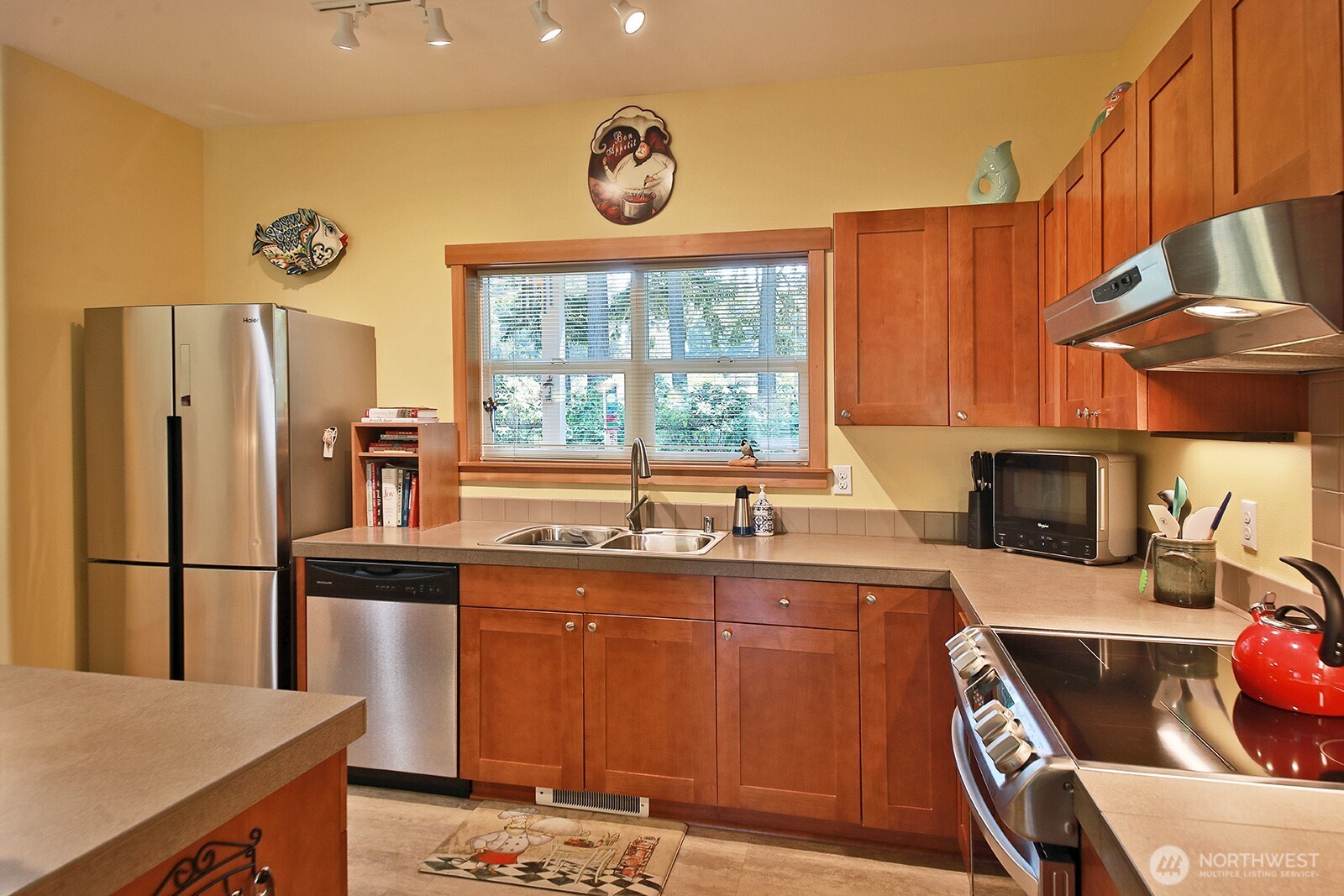 1050 Village Loop Langley, WA 98260 - Photo 24 of 39 a kitchen with stainless steel appliances granite countertop a sink stove and refrigerator