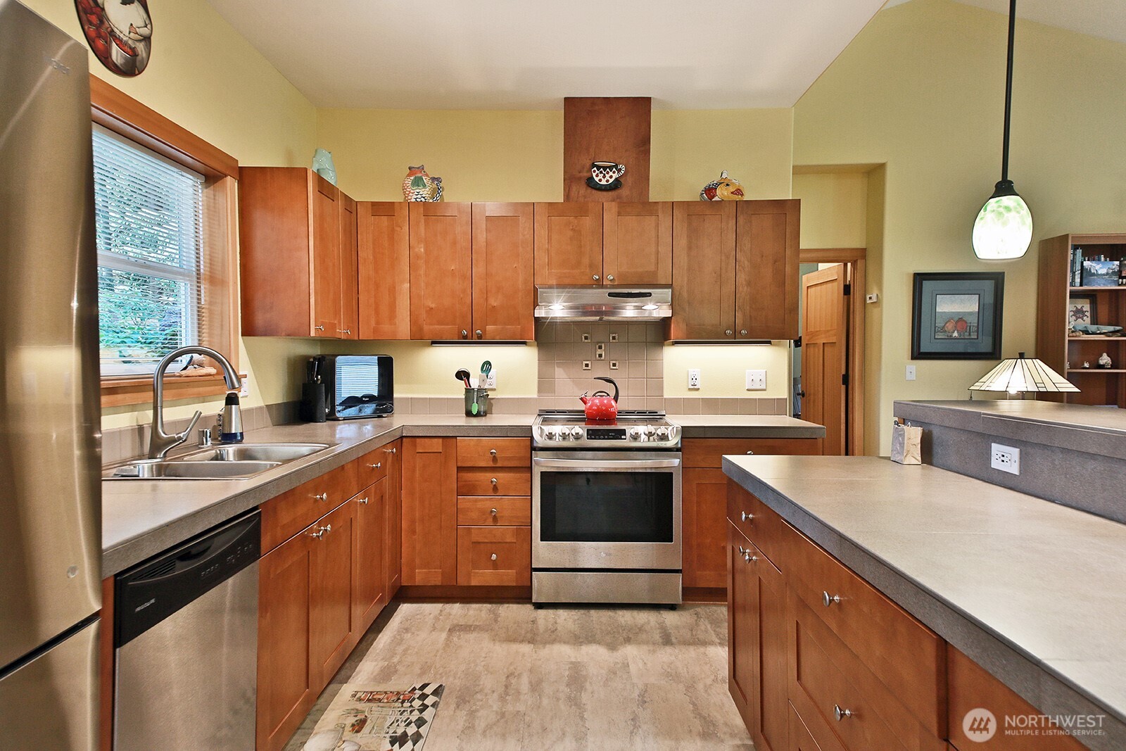 1050 Village Loop Langley, WA 98260 - Photo 25 of 39 a kitchen with a stove a sink and a refrigerator