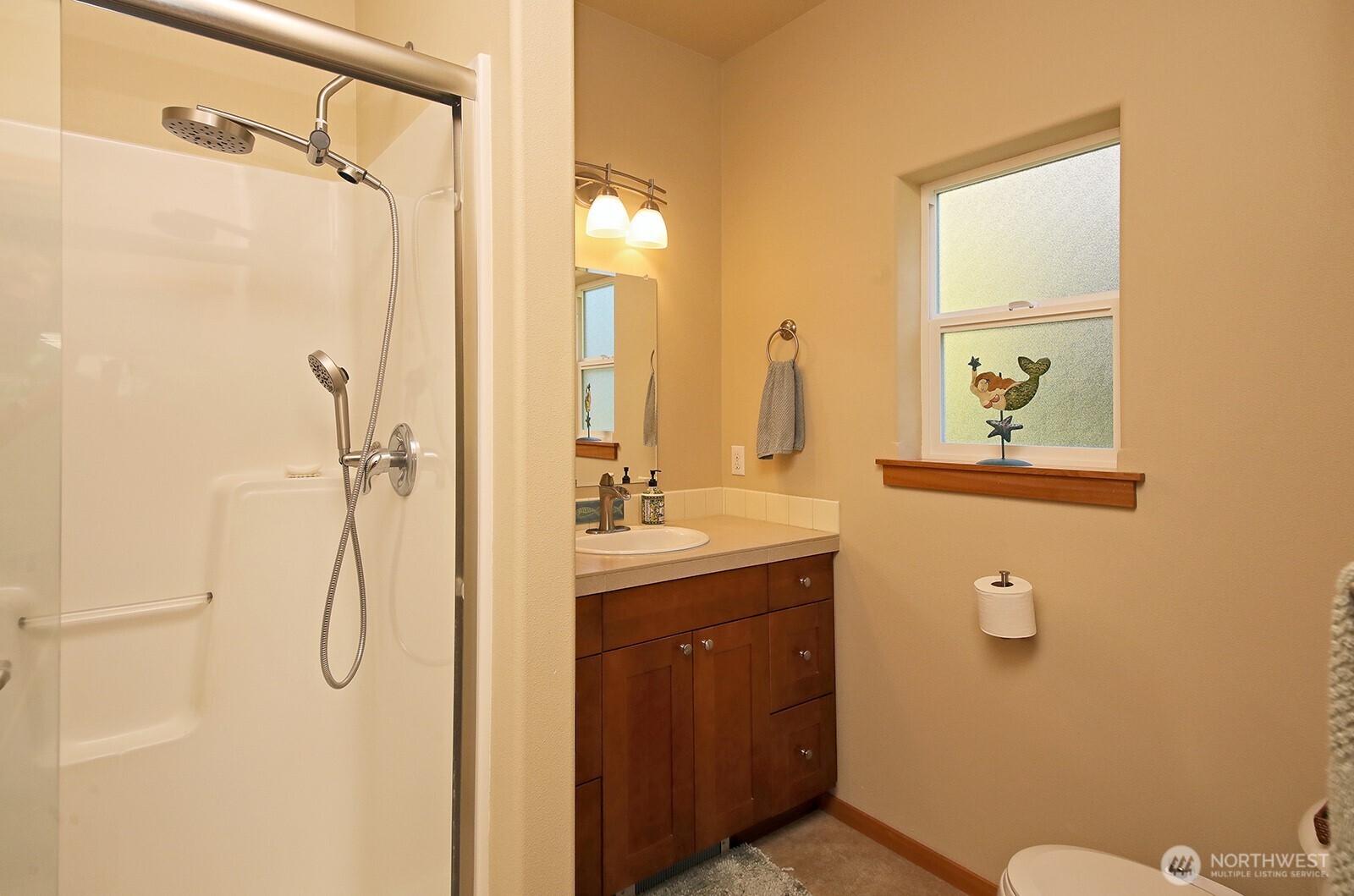 1050 Village Loop Langley, WA 98260 - Photo 34 of 39 a bathroom with a granite countertop sink a toilet and shower