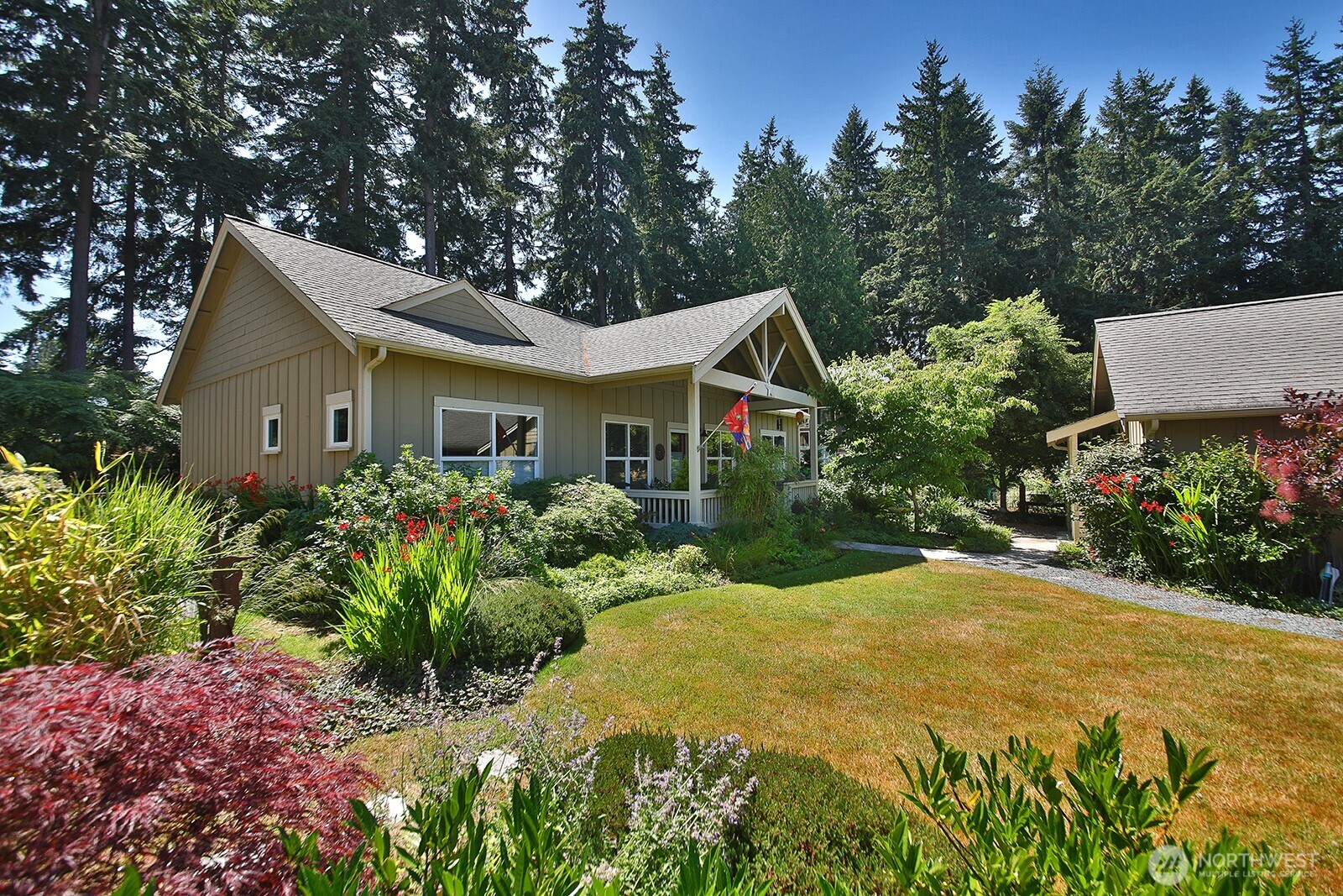 1050 Village Loop Langley, WA 98260 - Photo 4 of 39 a front view of a house with a garden