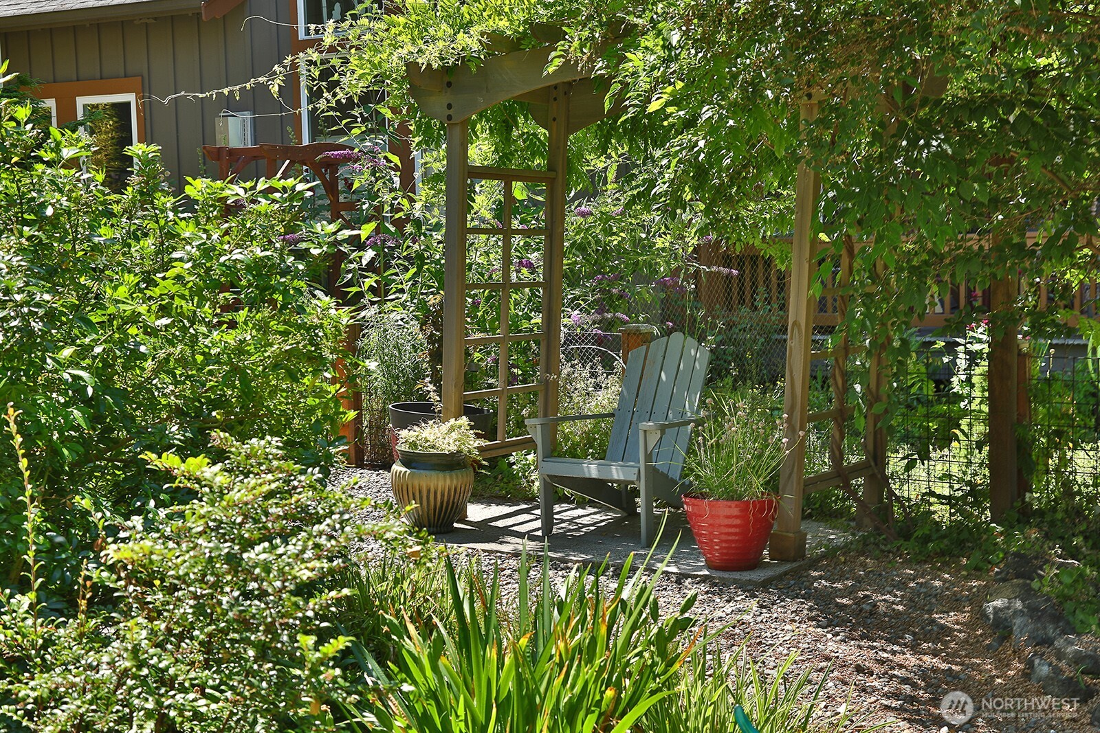 1050 Village Loop Langley, WA 98260 - Photo 10 of 39 a view of a backyard with table and chairs and potted plants