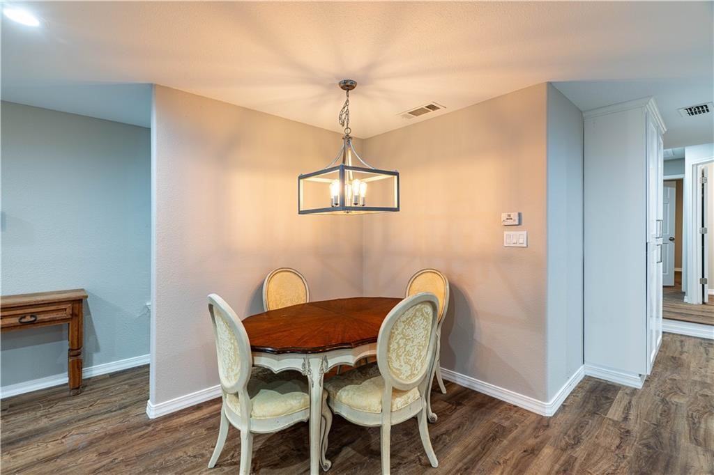 715 Bosquez Street Robstown, TX 78380 - Photo 7 of 18 a dining room with furniture a chandelier and wooden floor
