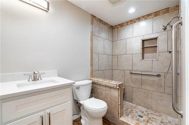 a bathroom with a sink toilet and shower