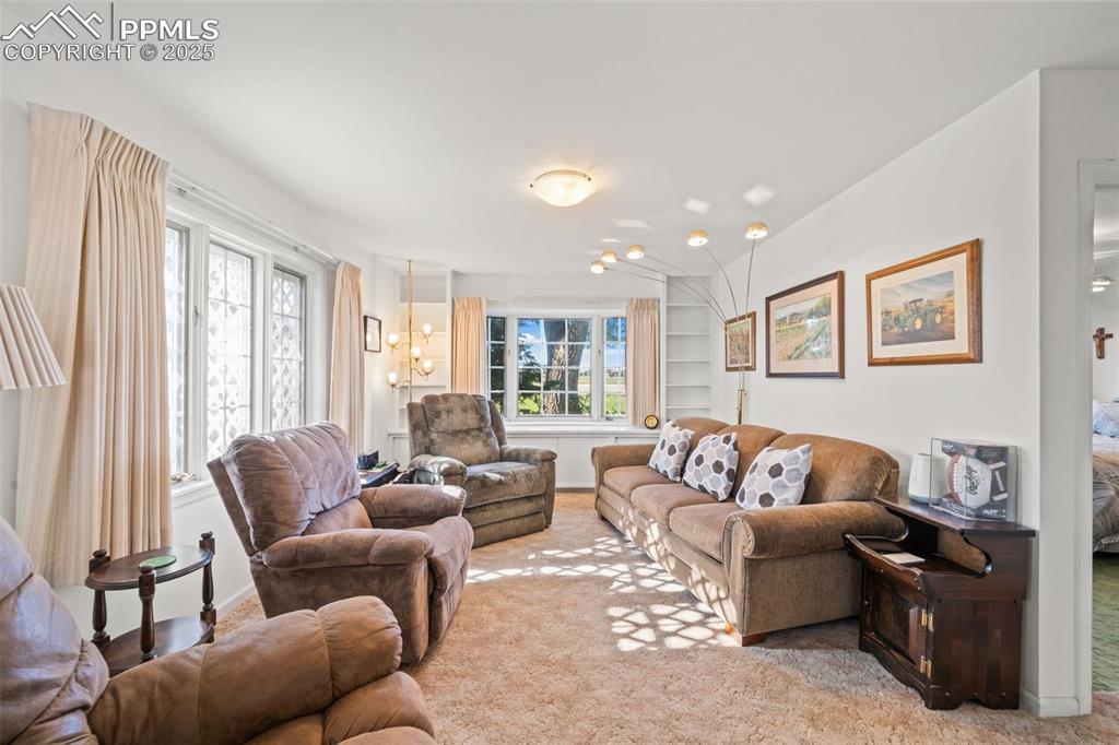 1805 West County Road 8 Berthoud, CO 80513 - Photo 31 of 48 a living room with furniture and a large window